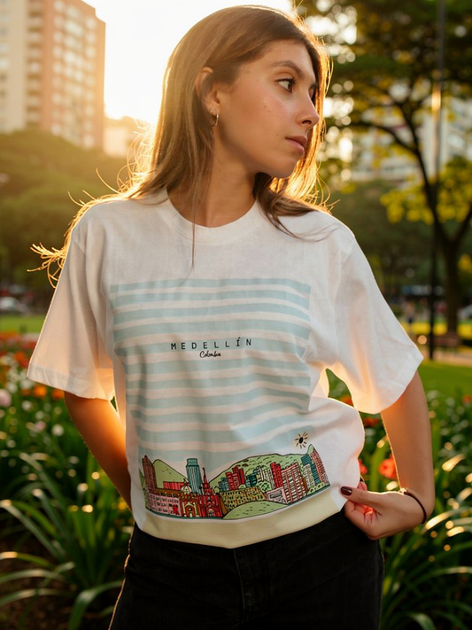 Woman wearing a t-shirt with 'Medellín' design in an outdoor setting