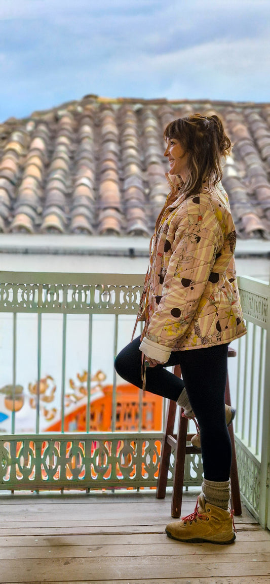Person standing on a balcony with tiled roof and colorful railing